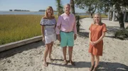 As seen on HGTV's Beach Hunters, homebuyers Tara and Rick and realtor Angela Johnson pose for a photo after touring the Sail Away House in Fripp Island, South Carolina.