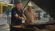 Wayde King talks to a client about the piano.