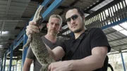 YANGON, MYANMAR - Sam and Robert Joe get up close and personal with a baby man-eating crocodile, which can grow to three times the height of a human.