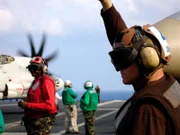 A plane Captain signals to the pilot - you're clear to go.