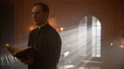 Der Priester liest aus dem Buch.
