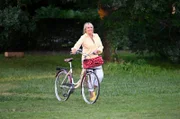 Mechthild Fehrenbach (Diana Körner) kommt mit dem Fahrrad und bringt Torte mit.