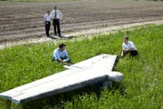 Deepak Joshi (Richard Young, vorne l.) und Jim Ritter (Noah Davis, vorne r.) untersuchen das Höhenleitwerk des Continental Express Pendler Jets, welches ca. 6000 Meter entfernt von der Absturzstelle des Continental Express Embraer Flugs 2574 aufgefunden wurde ...