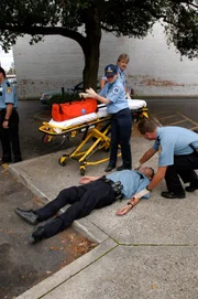 An ambulance takes care of a wounded police officer.
