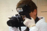 The investigator photographs the evidence.