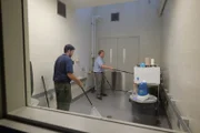 Bill Orrico and Kevin Torregrosa handle the male king cobra.
