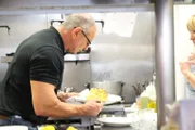 Robert inspects cauliflower, as seen on Restaurant Impossible.