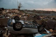 An overturned car lies on the foundation of a home near St. John's Regional Medical Center on May 23, 2011 in Joplin, Missouri. A powerful tornado ripped through the densely populated town of Joplin yesterday killing at least 89 people.