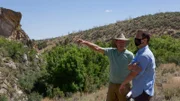 Eric Drummond points an area of land out to the Producer.