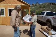 Eric Drummond and Duane Ollinger look at a map of Blind Frog Ranch together.