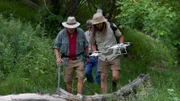 L-R: Eric Drummond, Chad Ollinger, Charlie Snider carry a drone through the trees.