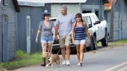 BOAT TRAINING:  Lizzy walking with the adopters and Minipants on a leash.