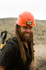 Chad Ollinger stands with a hard hat on, smiling