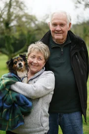 Karen and Howard pose for a photo with their newly adopted rescue McGee.