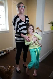 April poses with Zoe who is holding Eggo on her adoption day.