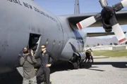 Bear Grylls and cameraman beside Hercules in New Zealand.