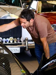 Elvis looking at the car.