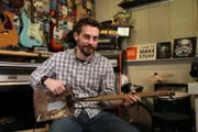Robert Clagett holds the shovel guitar.
