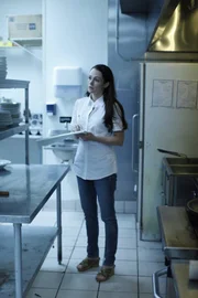 Lynn taking inventory in restaurant kitchen.