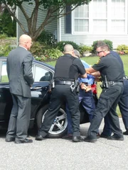 Police arrest Richard in his car.