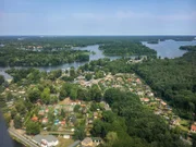 Aerial of Berlin with districts of Spandau and Reinickendorf and with Lake Tegel on a sunny summer day