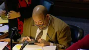 Ein Mann sitzt an einem Tisch und hält ein Gerät