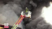 A column of black smoke hangs over the city while emergency services tries to bring the inferno under their control.