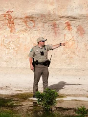 Fish and Game Officer Forrest Price at historial native painting site.