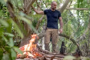 PELELIU, PALAU - Ed Stafford uses his bushcraft skills to start a fire and other survival techniques.