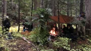 Danielle, Josh, and Dan sit by the fire.