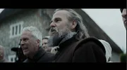 John Stearne stands among a group of angry villagers.