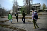 Fritz Meinecke, security guide Alexey, Wigald Boning and local guide Taras are seen on set during the shooting for the new local production 'Wigald & Fritz - Die Geschichtsjaeger' by the German TV channel HISTORY on April 12, 2016 in Pripyat, Ukraine.