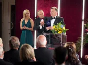 Dr. Roland Heilmann (Thomas Rühmann, rechts) bekommt von Prof. Simoni (Dieter Bellmann, Mitte) und einer Hostess (Komparsin) den Pasteurpreis verliehen. Seine Dankesrede widmet Roland vor versammeltem Publikum seiner Frau Pia - doch diese sucht er vergeblich unter den Zuhörern.