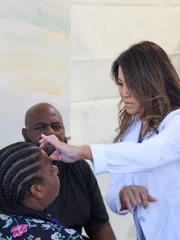 Dr. Sandra Lee feels the hidrocystomas on Ebonee P. left eye.