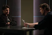L-R: Eli Newmore (DONALD MACLEAN JR) is interrogated by Charlie (JOHN REARDON)