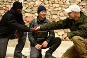 Hakim Isler and Ed Stafford having a handshake during briefing with Teddy