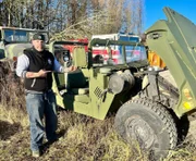 Mechanic expert from "Steel Buddy" stand next to the vehicle.