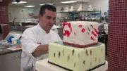 Buddy putting some finishing touches on the terrifying haunted house cake.