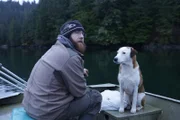 Oliver Johnson with his dog on his skiff in Port Protection.