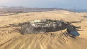 CGI of Alcatraz Island with waters drained away and Golden Gate Bridge in background.
