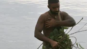 Max in the river building fish basket.