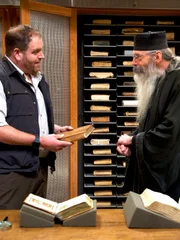 Josh Gates (l.) with Fr. Justin of Sinai in the monastery’s library in Sinai.