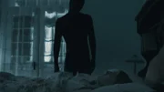 A person in black looking at a woman