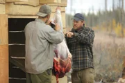 Tyler and Dustin skinning a moose leg.