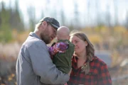 Selden family taking a break from building smokehut.