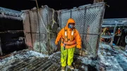 Wizard deckhand Gary standing by ice covered pots on deck