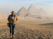 Ramy Romany walking away from pyramids.