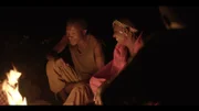 Hadzabe telling stories by the fire and laughing.