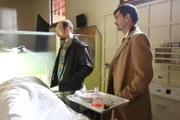 Detective Saucier and Jeff Stenner stand over a dead body.