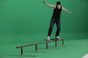 London, UK: A professional skateboarder showing how to perform a "Grind."